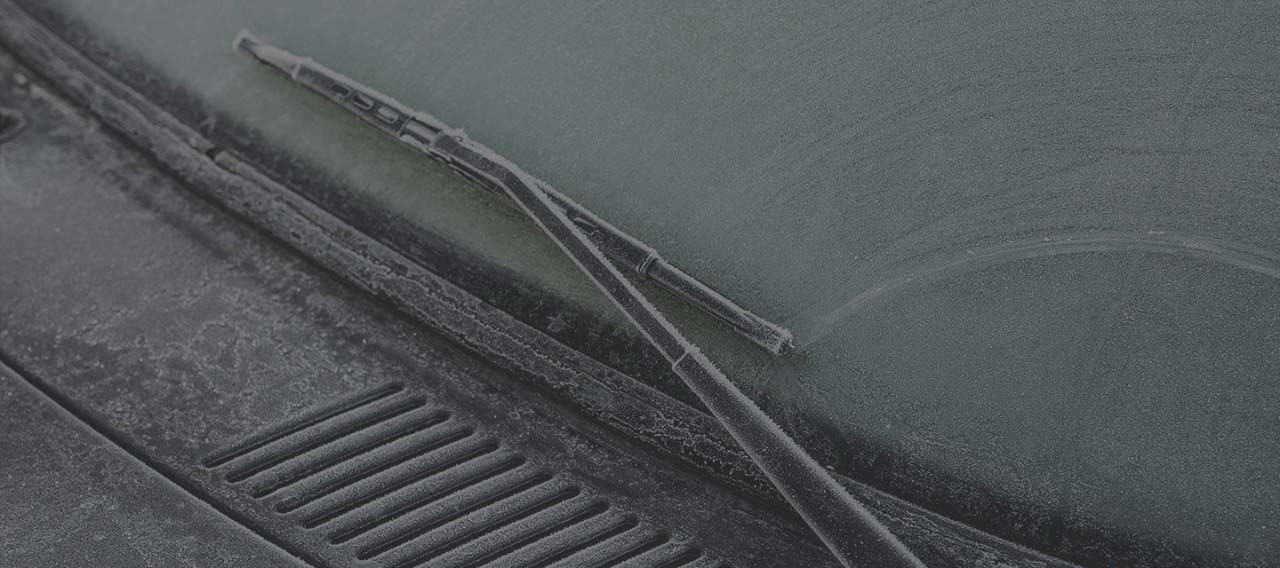Frost covered windshield and windshield wiper