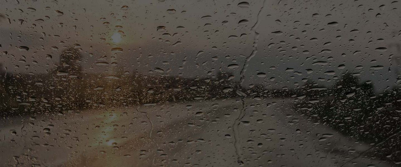 Rain drops on glass windshield